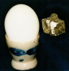 108 ct rough diamond next to an egg
