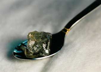 108ct. rough diamond shown sitting in a tablespoon